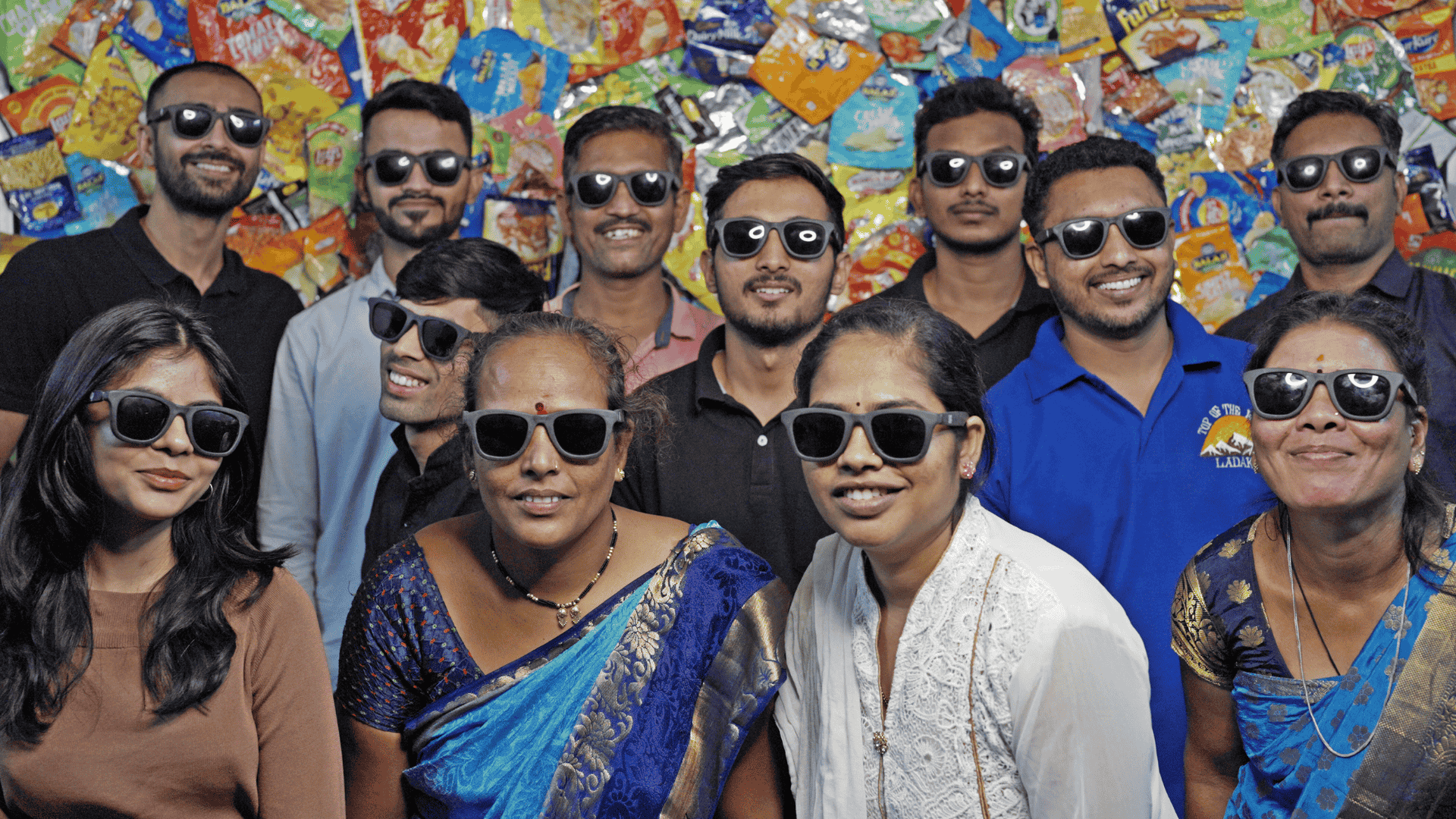Team members and waste workers at Without by Ashaya pose wearing sunglasses made from recycled MLP plastic, part of the Scale-Up program by Marico Innovation Foundation.