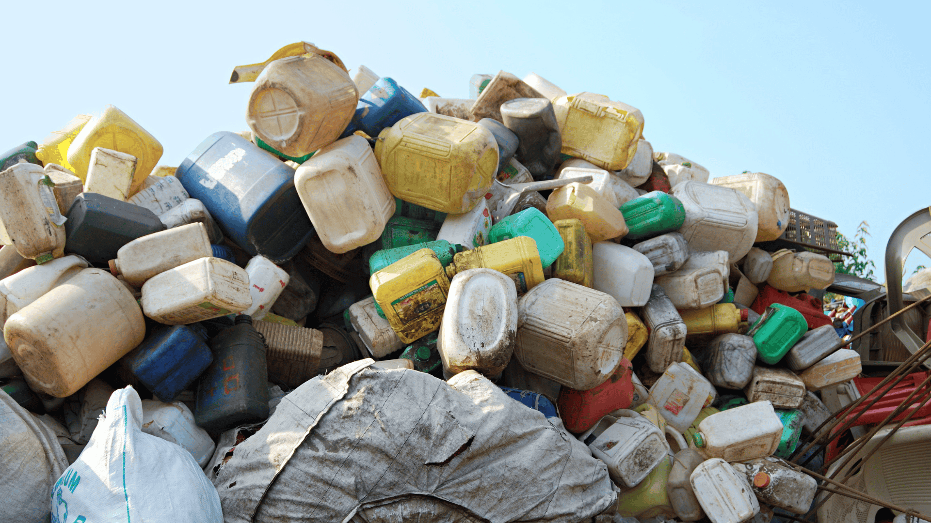 Pile of used plastic containers at a waste collection site in India, representing the plastic waste management challenge addressed by Marico Innovation Foundation’s Scale-Up program.