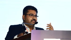 Bipin Odhekar, Head of Sustainability at Marico, speaking at a podium during a conference.