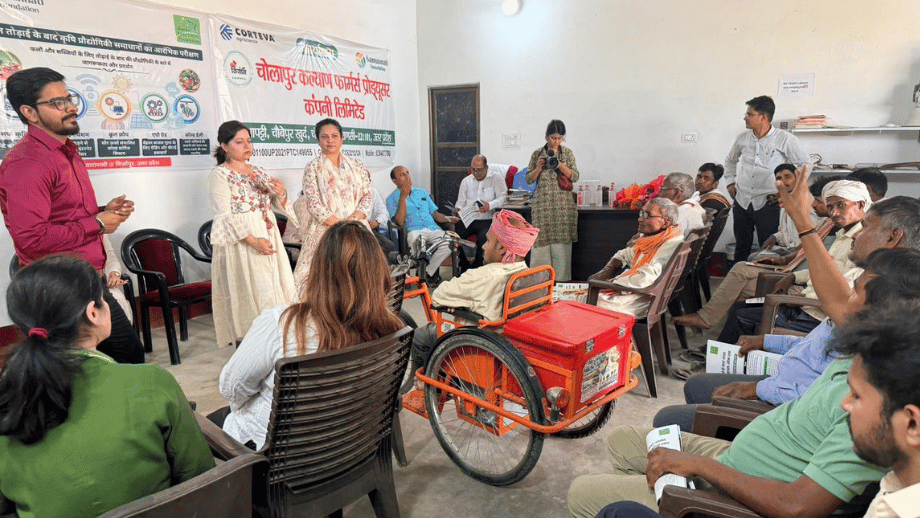 A group of people, including farmers and speakers, gathered in a room for a session on reducing post-harvest losses.