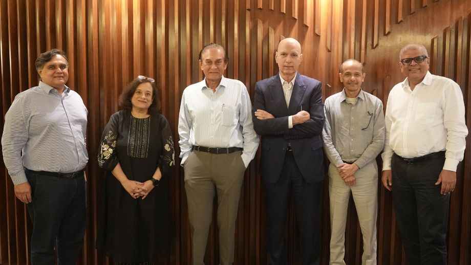 Five members of the Marico Innovation Foundation business jury posing for a group picture against a slatted wooden background.